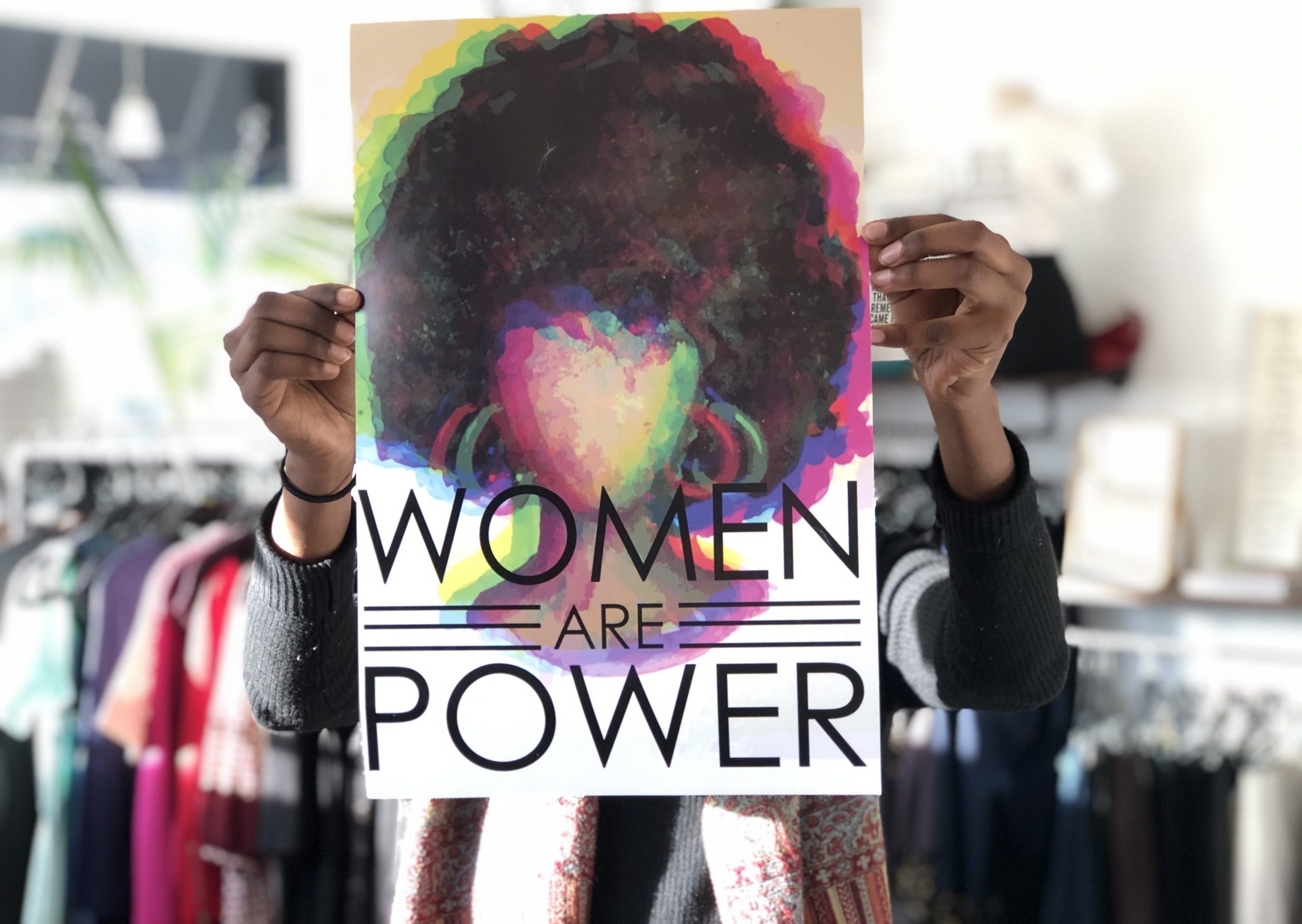 "Women are Power" sign held up at Sisterhood Boutique