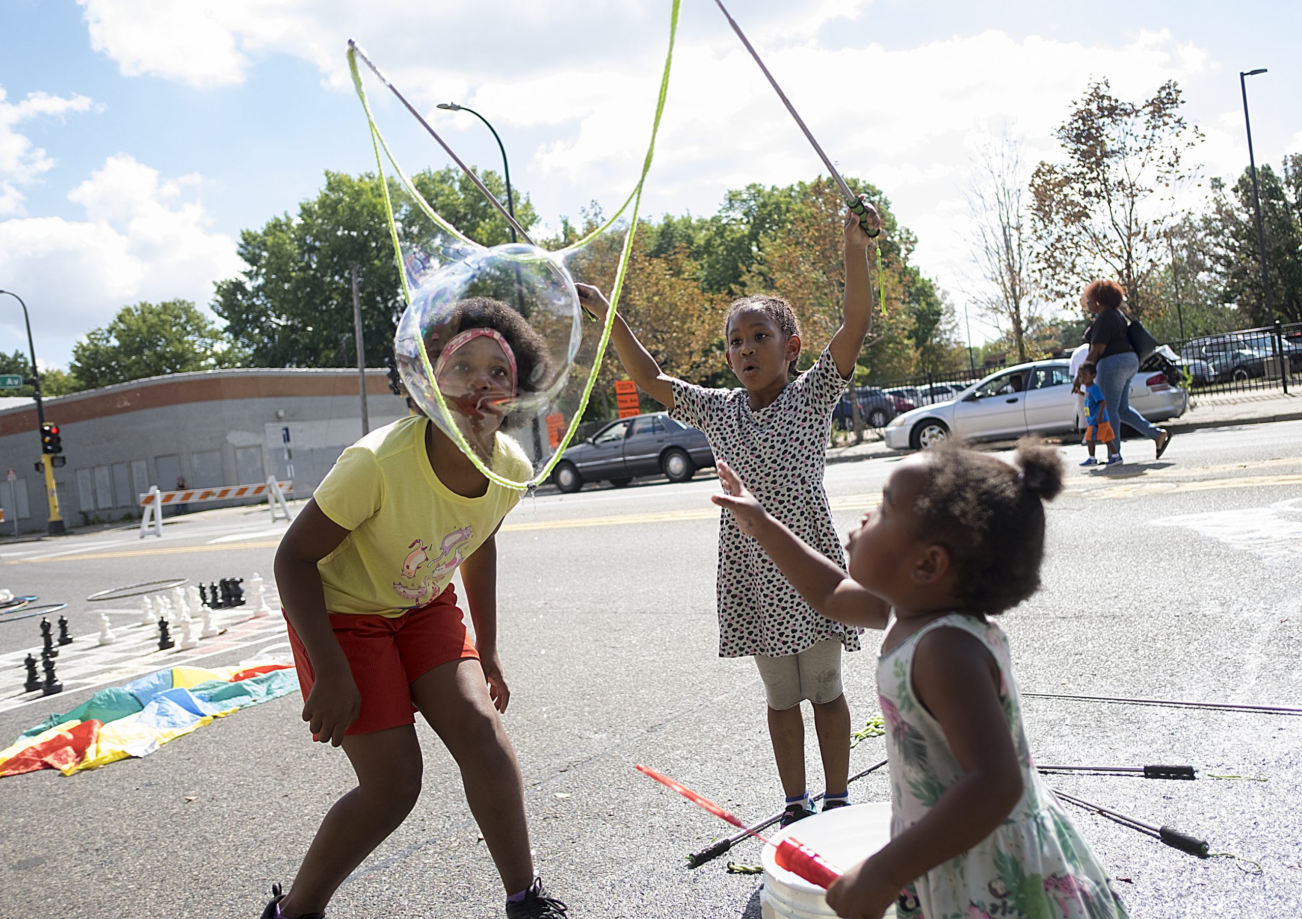 Young girls playing on Broadway Ave during Open Streets