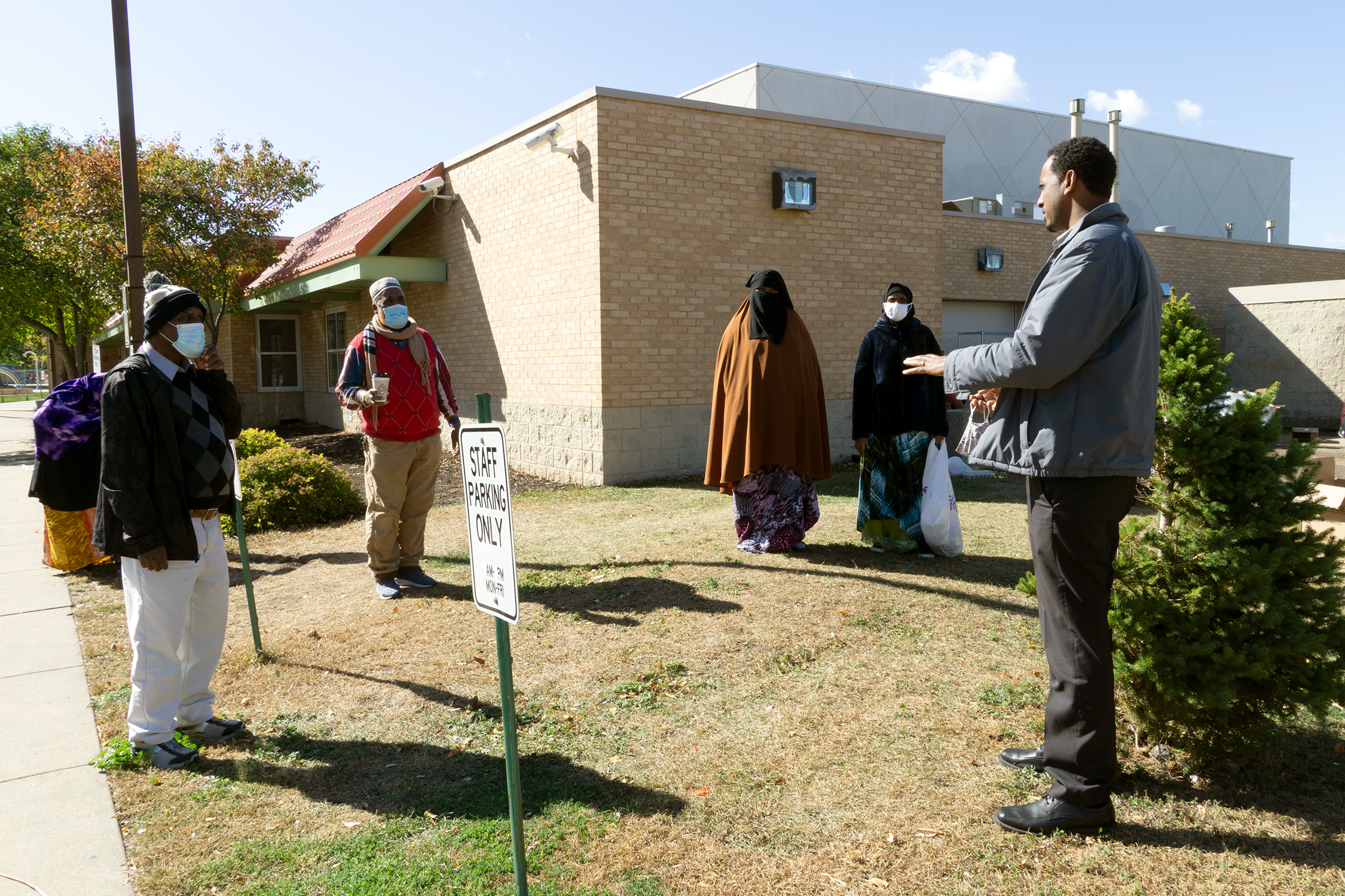 Community health worker and community members meeting outside Brian Coyle Center